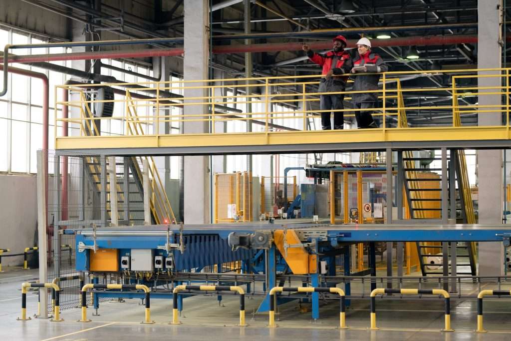 conveyor system in warehouse and two people