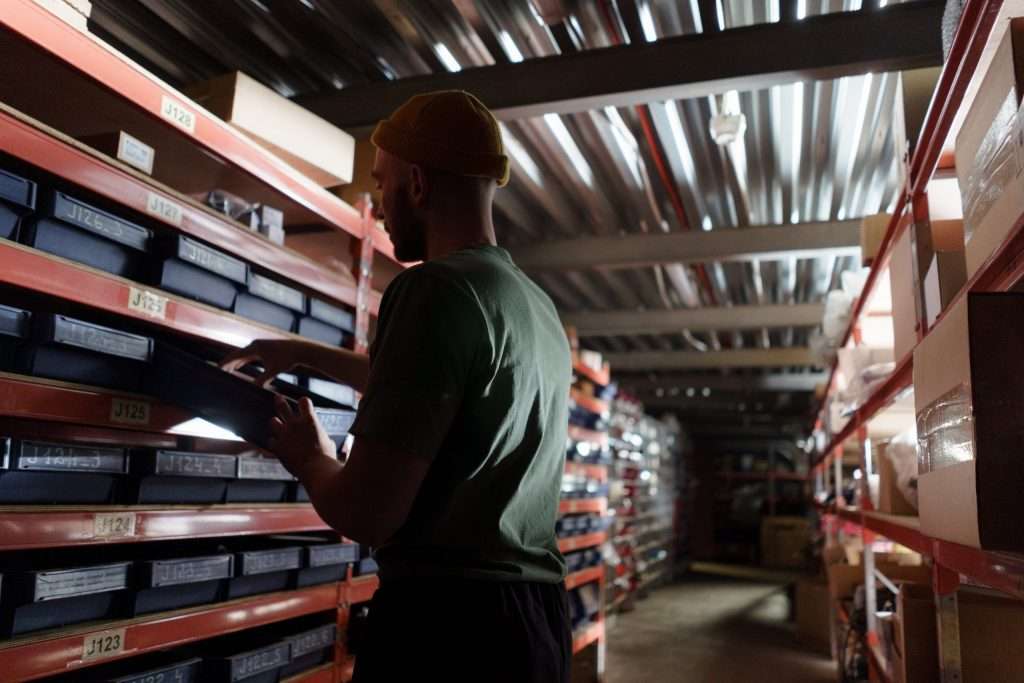 man using warehouse label in pallet rack area