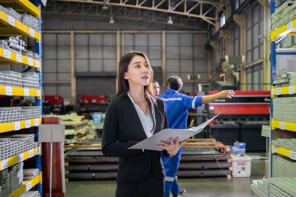 woman looking at pallet rack for inventory